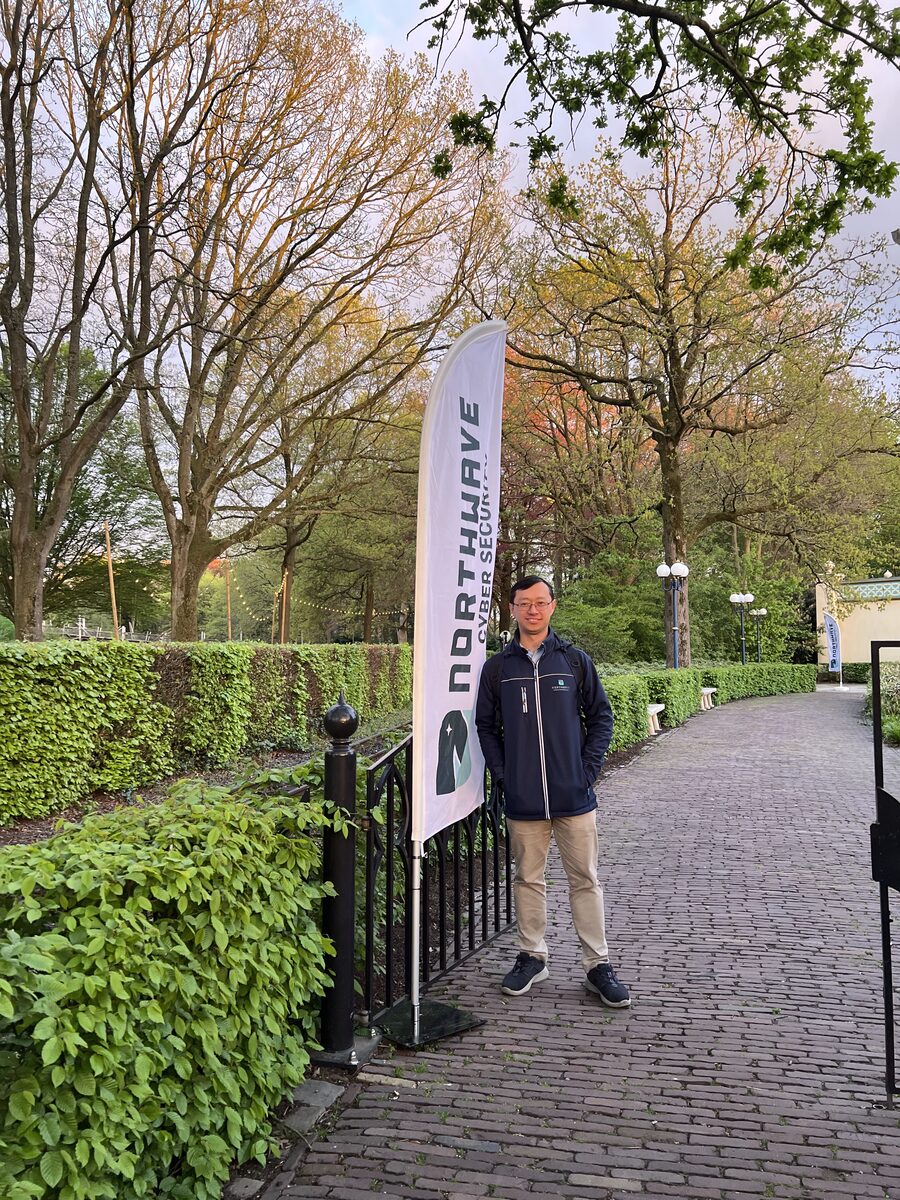 Fook Hwa Tan beside a Northwave banner at a company event